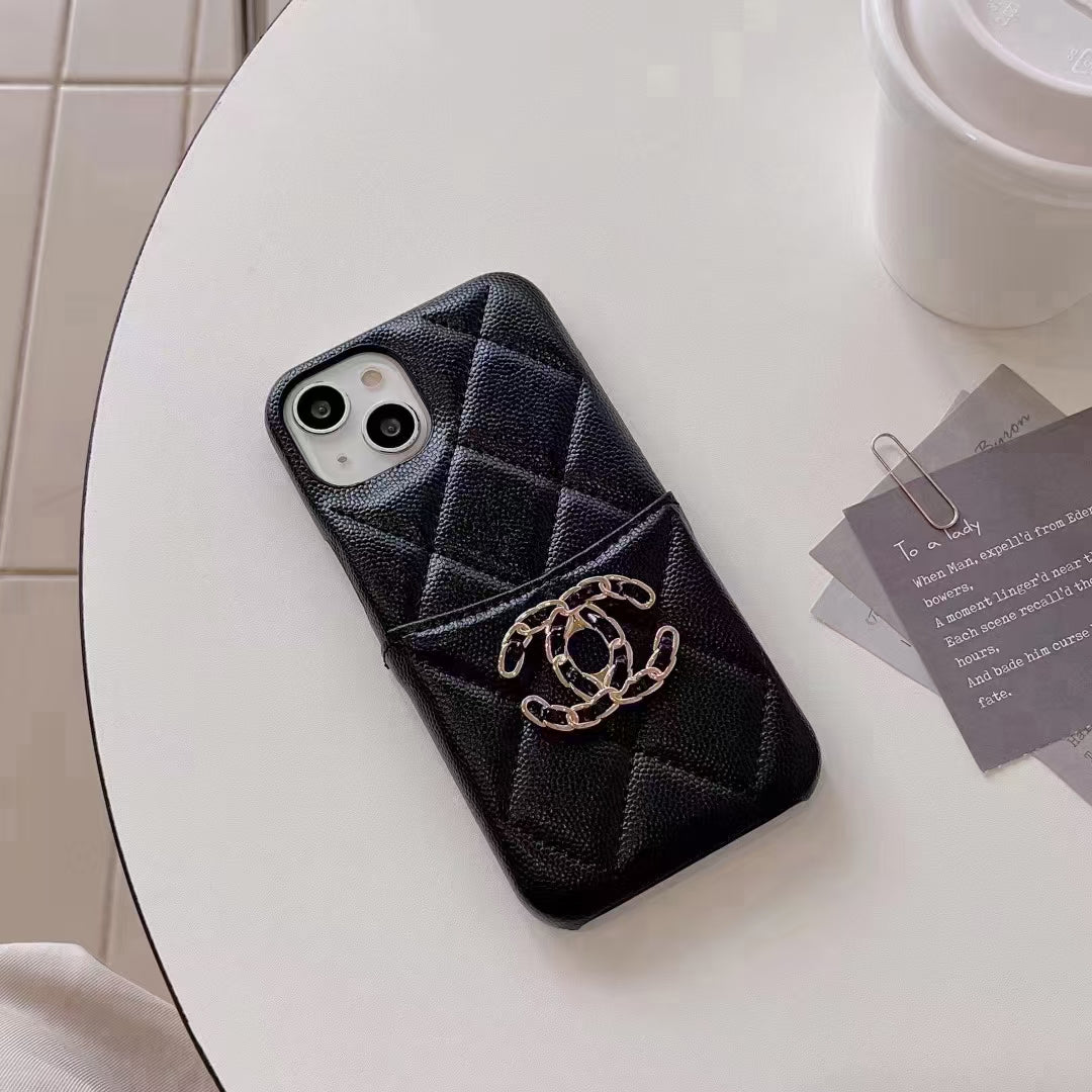 Detailed shot of the Chanel iPhone Case’s card holder with business cards neatly organized inside