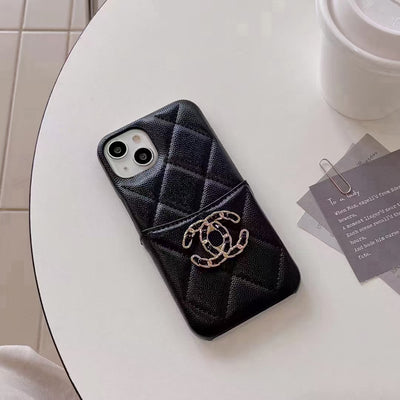 Detailed shot of the Chanel iPhone Case’s card holder with business cards neatly organized inside