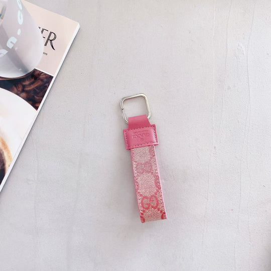 Gucci Keychain displayed against a minimalist background