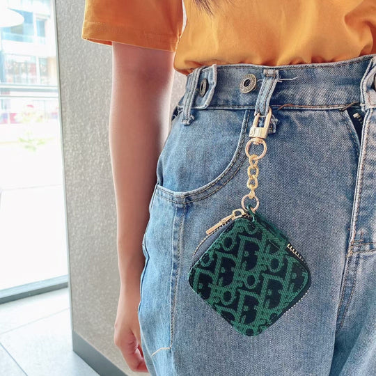 Lifestyle shot of the Luxury Dior AirPods Case &amp; Bag being used as a stylish mini-bag
