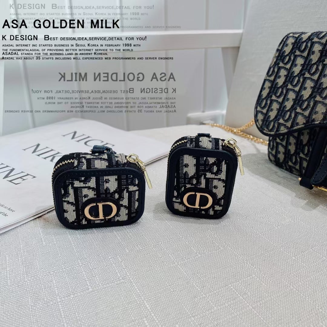"Flat lay of Dior AirPods Case &amp; Bag with AirPods.