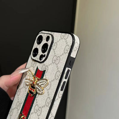 Close-up of Gucci phone case showing the iconic logo and hand strap