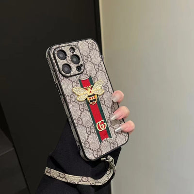 Gucci phone case with hand strap displayed on a white background