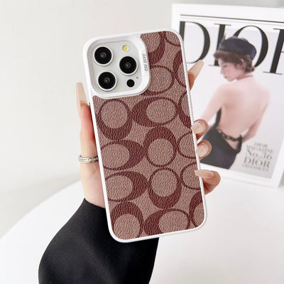 Coach iPhone Case held in hand, highlighting its smooth texture and refined design