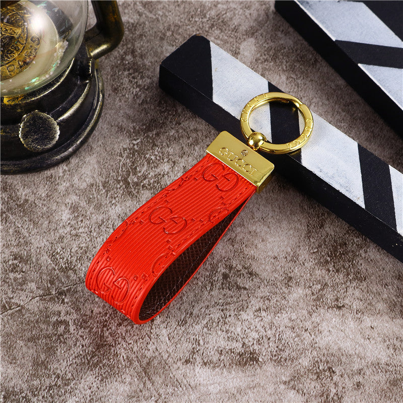 Gucci Keychain featuring the iconic logo and luxurious design, displayed against a neutral backdro