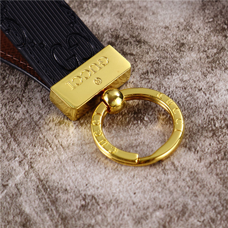 Gucci Keychain featuring the iconic logo and luxurious design, displayed against a neutral backdro