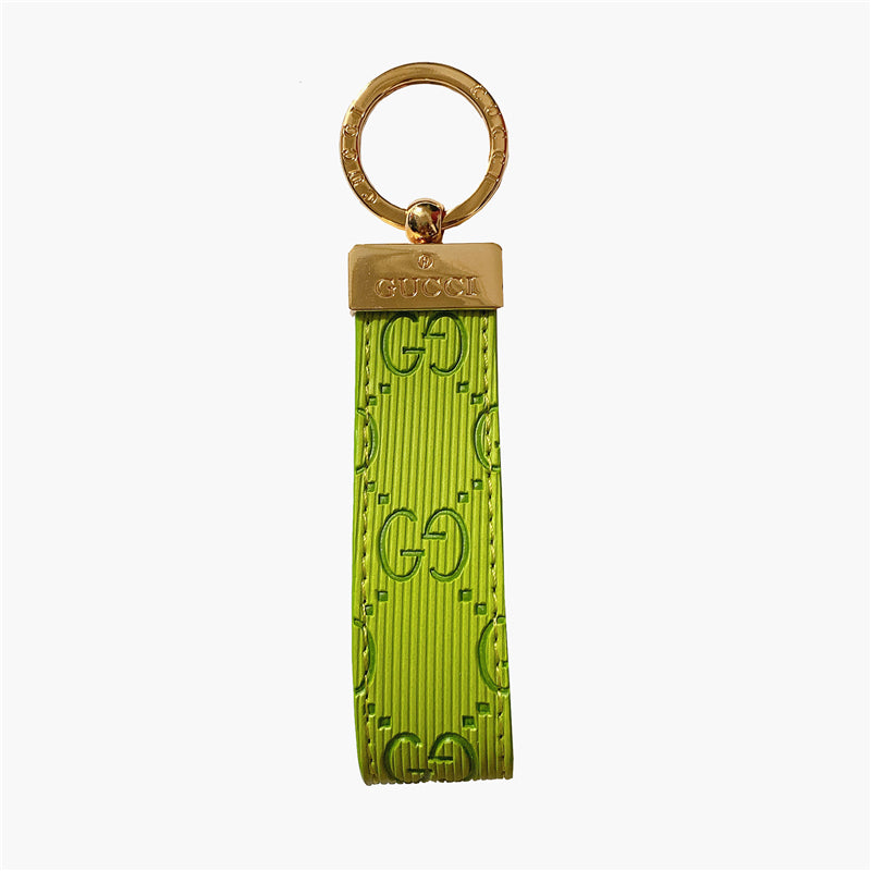 Gucci Keychain featuring the iconic logo and luxurious design, displayed against a neutral backdro