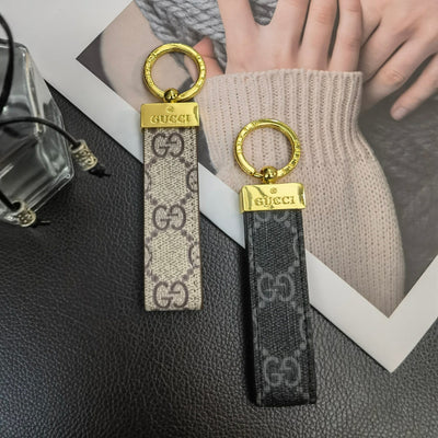 Gucci Keychain displayed on a sleek, modern background to highlight its luxury design