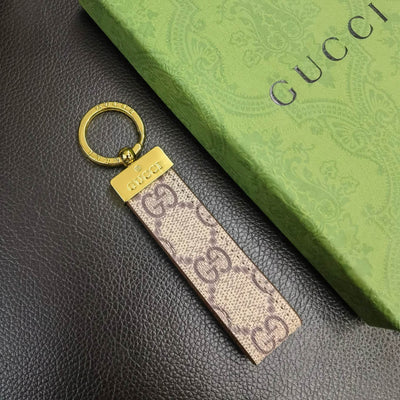 Elegant Gucci Keychain attached to a high-quality leather bag