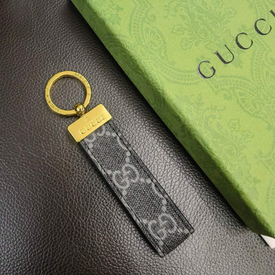 Gucci Keychain placed on a minimalist surface, emphasizing its sophisticated style