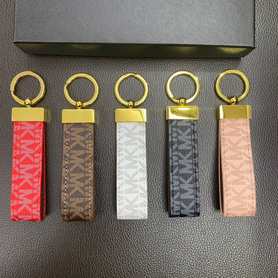 Close-up of the iconic Michael Kors logo on the keychain