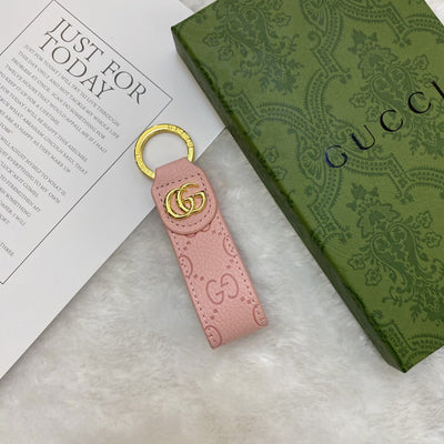 Gucci Keychain displayed on a sophisticated background to highlight its timeless design